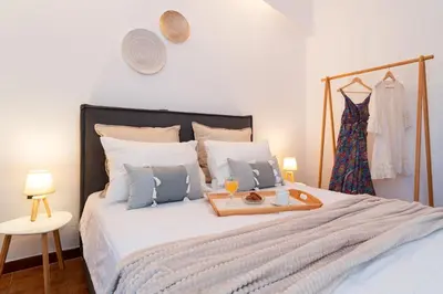 a bedroom with a bed with a tray of food on it at Ixian Bliss Pool Villa in Ialyssos