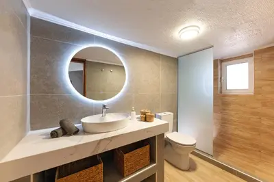a bathroom with a sink and a mirror at Ixian Bliss Pool Villa in Ialyssos
