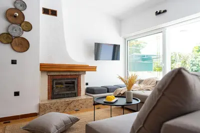a living room with a couch and a fireplace at Ixian Bliss Pool Villa in Ialyssos