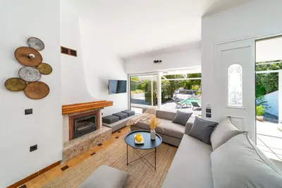 a living room with a couch and a fireplace at Ixian Bliss Pool Villa in Ialyssos