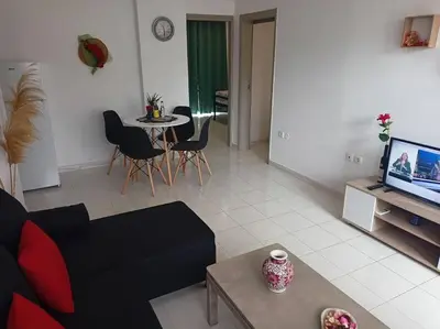 a living room with a couch and a table at Hibiscus Green Appartments 1 in Afantou