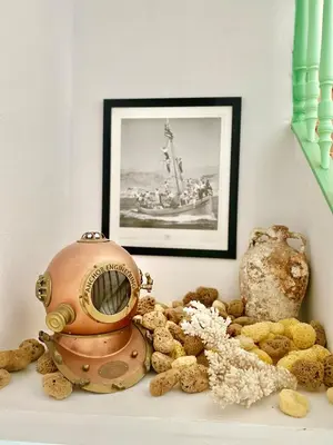 a pile of stuffed animals on a shelf with a picture at “Athenas” Neoclassic Harbour View Apartment in Symi