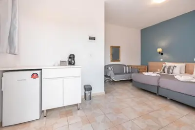 a living room with a bed and a couch at Eva's Rooms in Faliraki