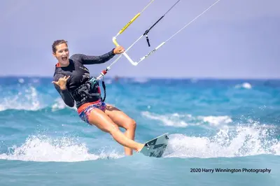 a man riding a wave on a surfboard in the ocean at LOGOS Beach Village in Theologos