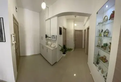 a large hallway with white cabinets and plants in it at The Cosy Nest -BREAKFAST INCLUDED & CAR RENTAL AVAILABLE in Rhodes Town