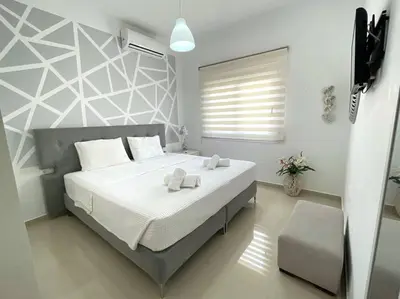 a bedroom with a bed with two towels on it at The Cosy Nest -BREAKFAST INCLUDED & CAR RENTAL AVAILABLE in Rhodes Town