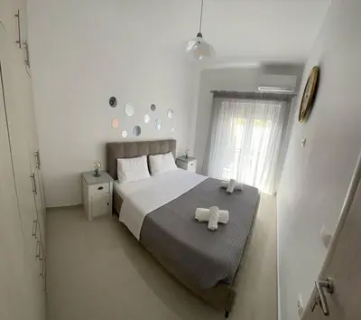 a bedroom with a bed with two white towels on it at The Cosy Nest -BREAKFAST INCLUDED & CAR RENTAL AVAILABLE in Rhodes Town