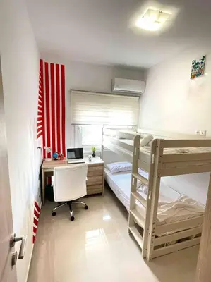a room with two bunk beds and a desk and a computer at The Cosy Nest -BREAKFAST INCLUDED & CAR RENTAL AVAILABLE in Rhodes Town