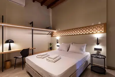 a bedroom with a large bed with towels on it at Oasis Luxury House in Rhodes Town