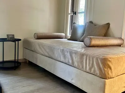a large couch sitting in a room with a window at Oasis Luxury House in Rhodes Town