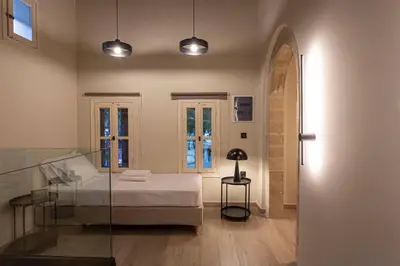 a bedroom with a bed and a glass table at Oasis Luxury House in Rhodes Town