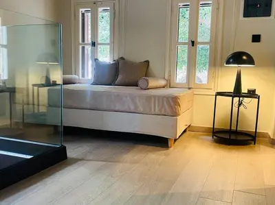 a bedroom with a bed and a glass wall at Oasis Luxury House in Rhodes Town