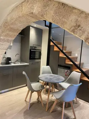 a room with a table and chairs and a kitchen at Oasis Luxury House in Rhodes Town