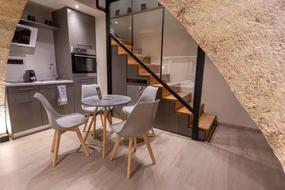a kitchen with a table and chairs and a staircase at Oasis Luxury House in Rhodes Town