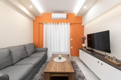 a living room with a couch and a flat screen tv at Modern Colorful House 2 rhodos in Rhodes Town