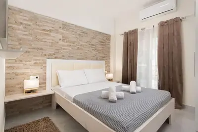 a bedroom with a large bed with two pillows at Modern Colorful House 2 rhodos in Rhodes Town